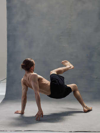 Young beautiful cool looking man posing in studioの写真素材