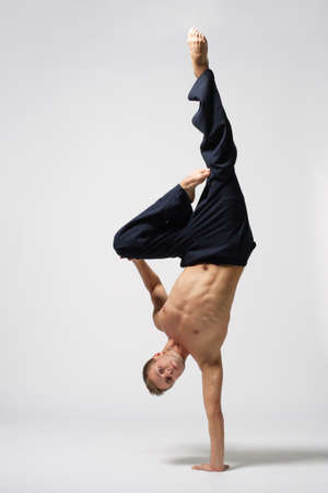 Young modern ballet dancer posing over white backgroundの写真素材