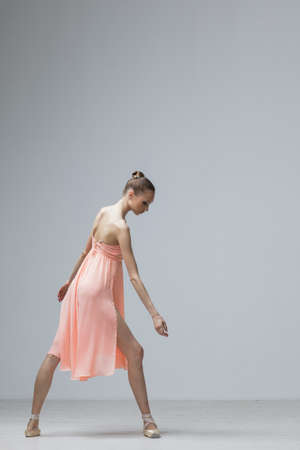 Young Beautiful Ballet Dancer Positioning on Studio Backgroundの写真素材