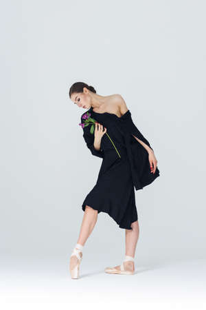 Elegant ballerina. A young graceful ballet dancer, dressed in pointes shoes demonstrates her dance skills. Power and refinement of classical ballet.の写真素材