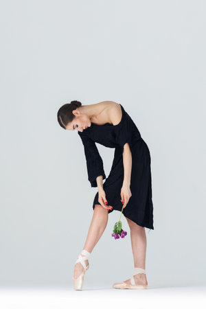 Elegant ballerina. A young graceful ballet dancer, dressed in pointes shoes demonstrates her dance skills. Power and refinement of classical ballet.の写真素材