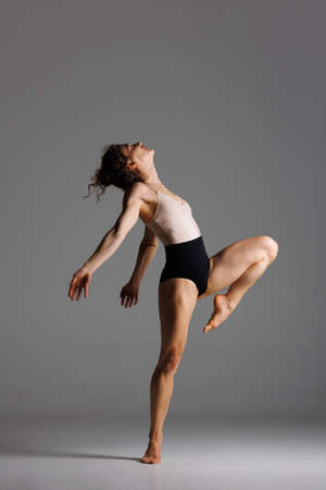 Young beautiful yoga female is exercising in studioの写真素材