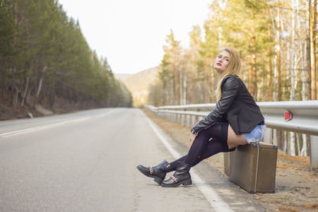 Beautiful young girl hitchhiking in the United States and Canada.の写真素材