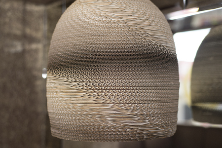 Beautiful designer lamp made of cardboard. The lamp is an important element of the interior.の写真素材