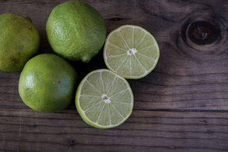 Cut Limes on Wooden Table