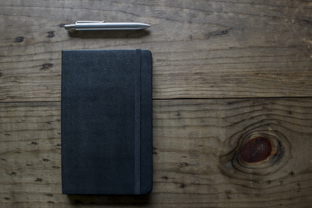 Black Leather notebook and silver penの写真素材