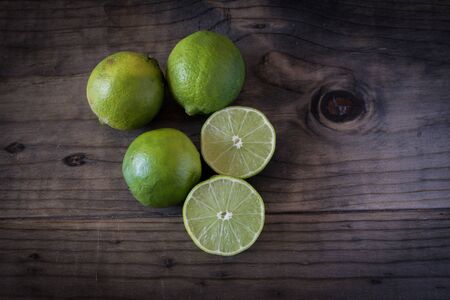 Cut Limes on wooden tableの写真素材