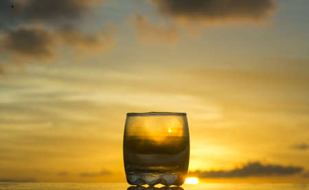 Sun set captures through a water glassの写真素材