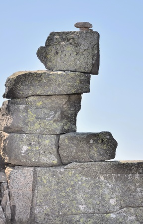 Cairn on rocky mountains on blue sky backgroundの写真素材
