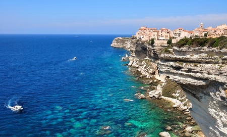 Village perched atop a limestone cliff on the Mediterranean coast (Bonifacio)の写真素材