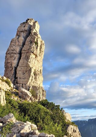 crack in a rocky peak in cloudy skyの写真素材