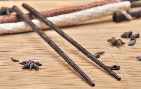 Various spices placed on a straw mat with chopsticks の写真素材