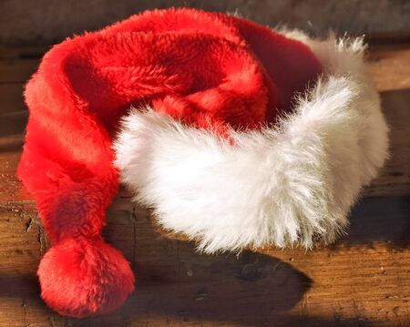 Christmas hat on a table in the darkの写真素材