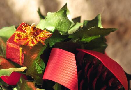 Christmas decoration made ââof leaves and a red ribbonの写真素材
