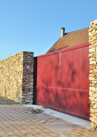 closed sliding gate between two stone walls