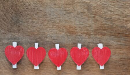 red hearts aligned on wooden backgroundの写真素材