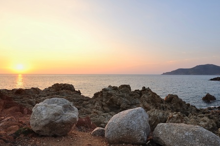beautiful sunset on the orange cliffs of a gulf in Corsicaの写真素材