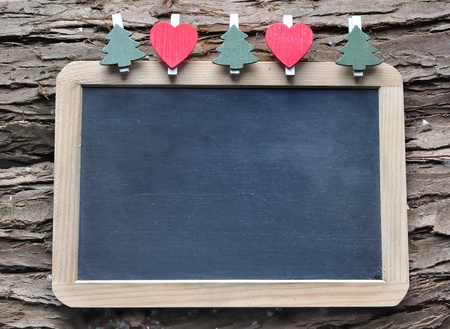 Slate for Christmas wishes on wooden backgroundの写真素材