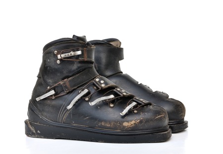 old ski shoes on white background