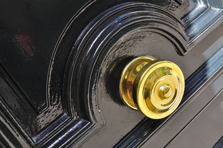 golden handle of a door painted blackの写真素材