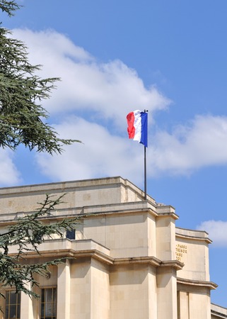 French flag fluttering in the sky on a Paris monumentのeditorial素材