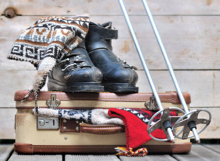 old ski boots on a small  suitcase full of warm clothesの写真素材