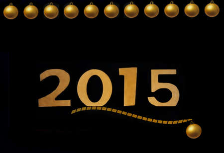greeting card with golden 2015 and Christmas balls on a black backgroundの写真素材