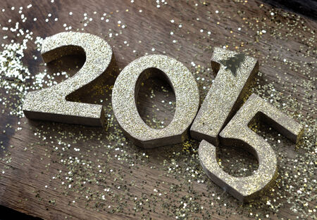 golden figure on wooden background with glittersの写真素材