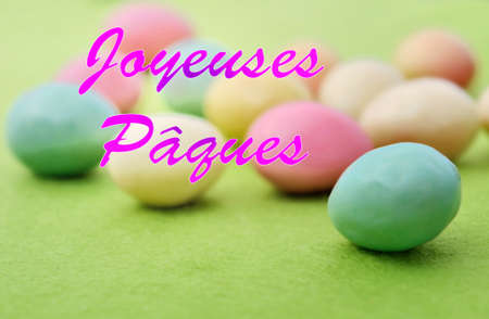 Happy Easter writing in french with little colorful eggs background
