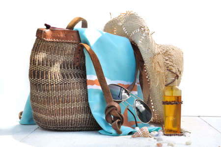 beach bag and accessories on white wooden plank  with shellsの写真素材
