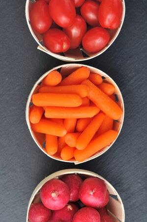 mixed vegetable in round keepnet on dark backgroundの写真素材