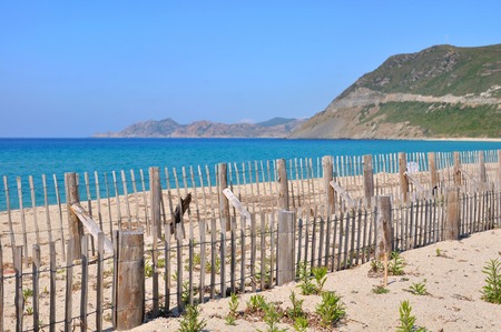 wooden fence on a Corsica beachの写真素材