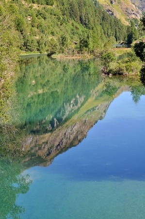 reflection of the mountain on the surface of the lake waterの写真素材