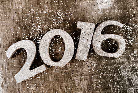 2016 figure on wooden plank with glitters