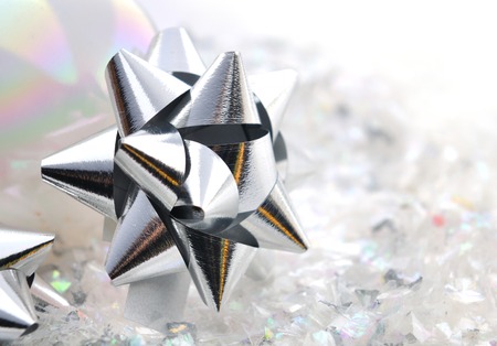 close on silver nodes  bright paper on confetti backgroundの写真素材