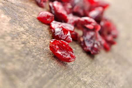 group of  dried cranberries on wooden plank