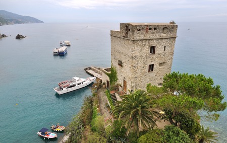 ancient genovese tower in seafront - Italy -の写真素材