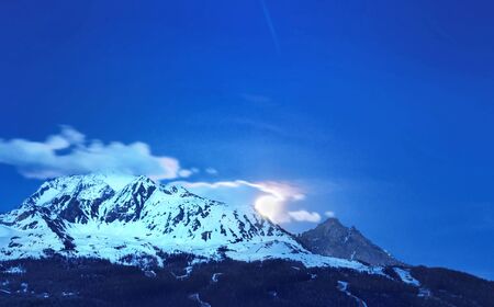 mountain landscape at night with rising moonの写真素材