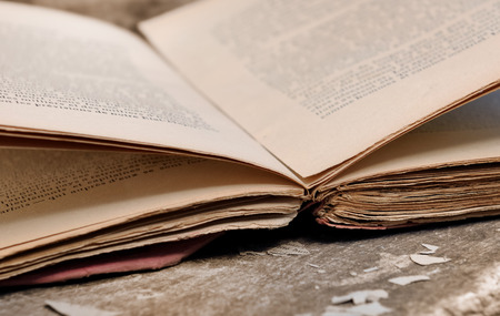 old book opening on a wooden plankの写真素材