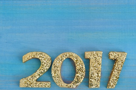 2017 with golden figureson blue wooden pannel background