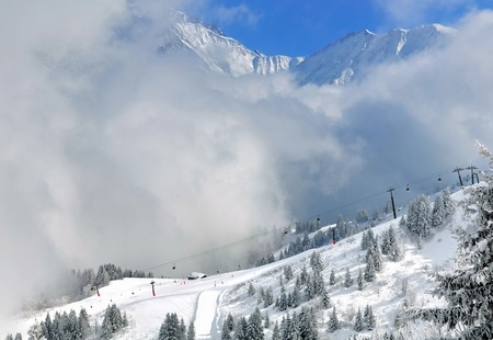 thick clouds on the ski slopes under white mountain