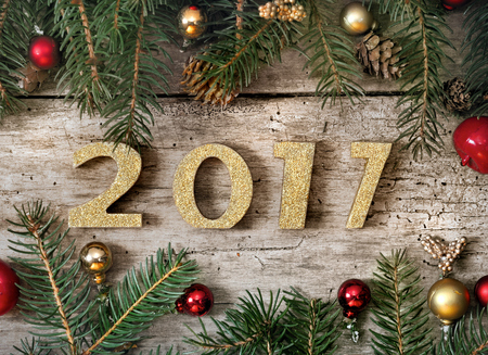 golden 2017 figure on a christmas decoration on wooden backgroundの写真素材