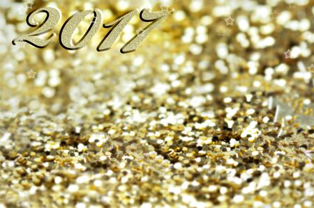 2017 writen on golden and bright confettis background