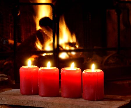 red candles in front of a fireplaceの写真素材