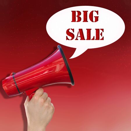 hand hanging a megaphone with text  big sale on red backgroundの写真素材