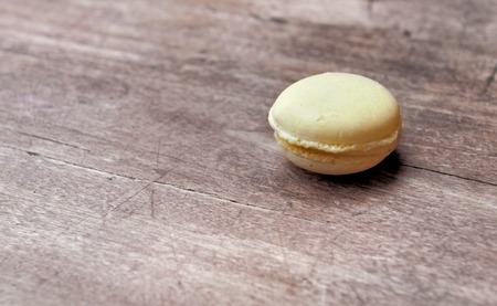 yelow macaroon on wooden table with vintage effectの写真素材