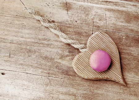 french macaroons on a wooden heart with vintage effectの写真素材