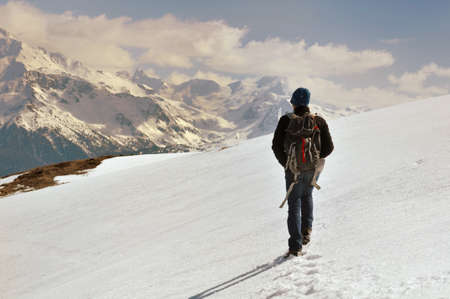 hiker with backback walking in the snow の写真素材