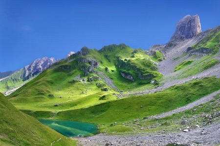 beautiful landscape of rocky and greenery mountain with a lake の写真素材