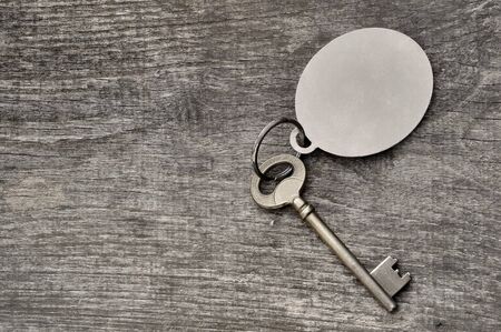 old key on a ring on wooden background 